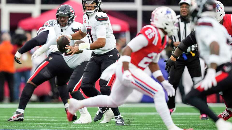 Houston Texans quarterback C.J. Stroud (7) rolls out to pass against the New England Patriots during the first half of an NFL football game Sunday, Oct. 13, 2024, in Foxborough, Mass.