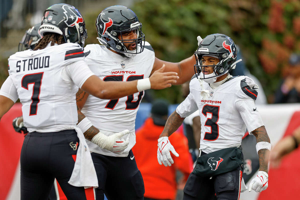 Houston Texans center Juice Scruggs (70) wide receiver Tank Dell (3) and quarterback C.J. Stroud (7) celebrate after a touchdown during the first half of an NFL football game against the New England Patriots, Sunday, Oct. 13, 2024, in Foxborough, Mass.