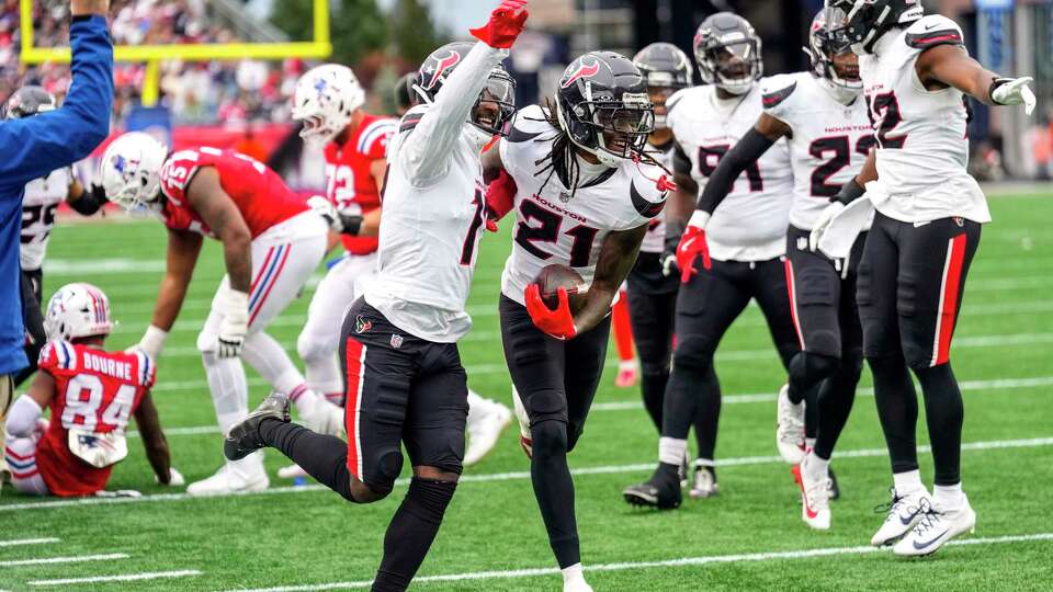 Houston Texans cornerback Kris Boyd (17) and Houston Texans safety Calen Bullock (21) celebrate Bullock's fumble recovery against the New England Patriots during the second half of an NFL football game Sunday, Oct. 13, 2024, in Foxborough, Mass.