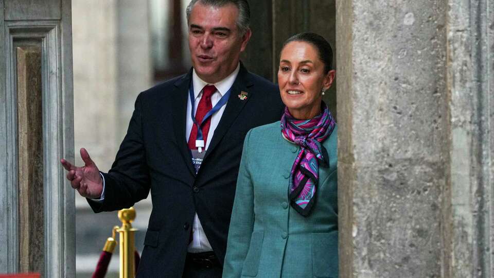 Mexican President Claudia Sheinbaum, right, and Mexican businessperson Francisco Cervantes arrive for a news conference at the National Palace in Mexico City, Tuesday, Oct. 15, 2024.