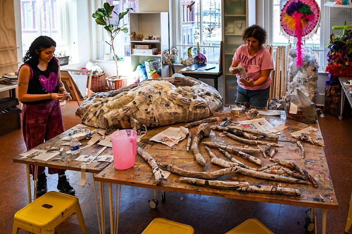 Members of the Krewe of Misfits work on a giant spider puppet that will require 17 people to move during next Saturday's Mystical Parade of Boo in downtown Galveston.