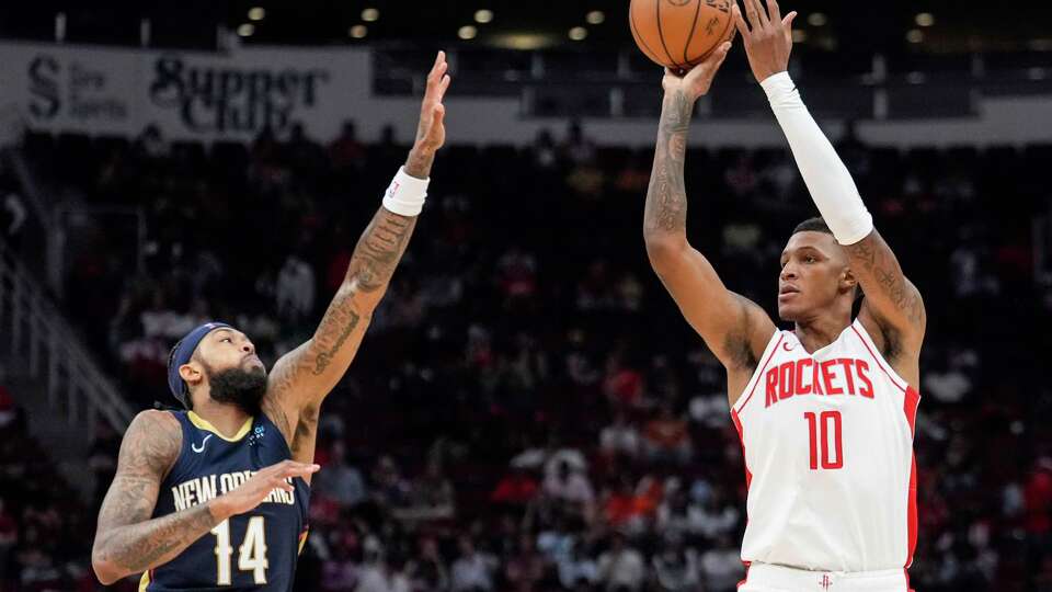 Houston Rockets forward Jabari Smith Jr. (10) takes a shot against New Orleans Pelicans forward Brandon Ingram (14) during the second half on a preseason NBA basketball game on Tuesday, Oct. 15, 2024 in Houston.