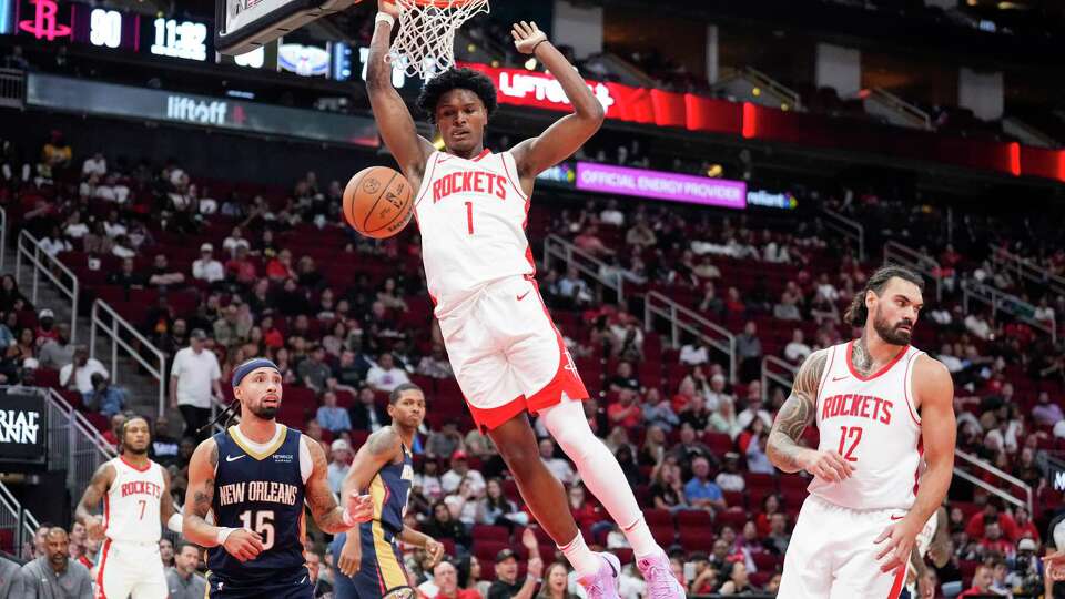 Houston Rockets forward Amen Thompson (1) dunks against New Orleans Pelicans guard Jose Alvarado (15) during the second half on a preseason NBA basketball game on Tuesday, Oct. 15, 2024 in Houston.