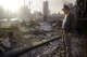 A man looks over the remains of his home in the Granada Hills area of Los Angeles, after a gas main ruptured, caught fire and destroyed his home in the wake of the 1994 Northridge earthquake.