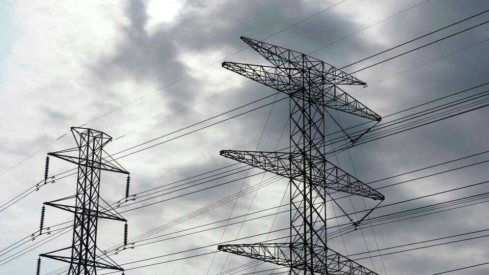 Transmission power lines are shown along Sam Houston Tollway at Hollister St. Wednesday, Oct. 16, 2024, in Houston.