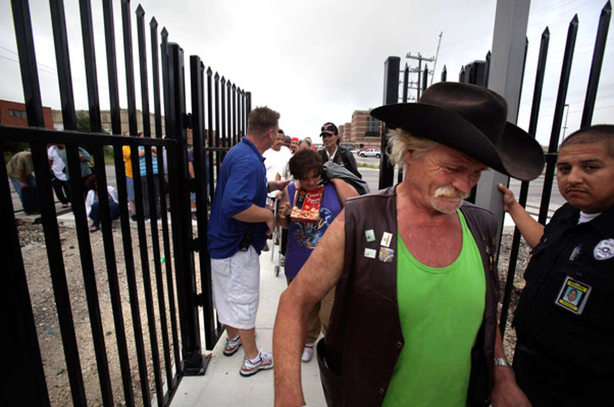 On the way to hope: Charles Kania (in cowboy hat) is the first to enter Haven for Hope?s Prospects Courtyard. About 30 members of San Antonio?s homeless population were processed into Prospects Courtyard on Saturday. The homeless facility has been opening in stages.
