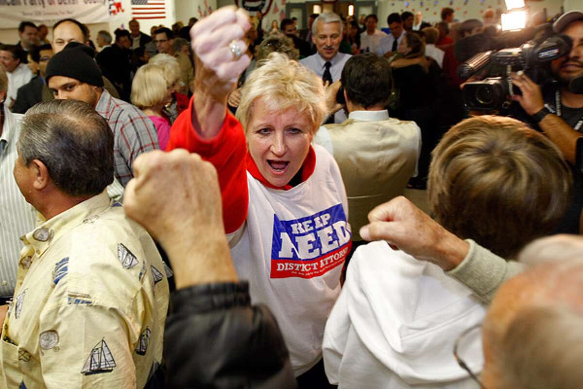 Bexar County District Attorney Susan Reed raises her fist in victory with supporters as she arrives at the Bexar County Republican headquarters.