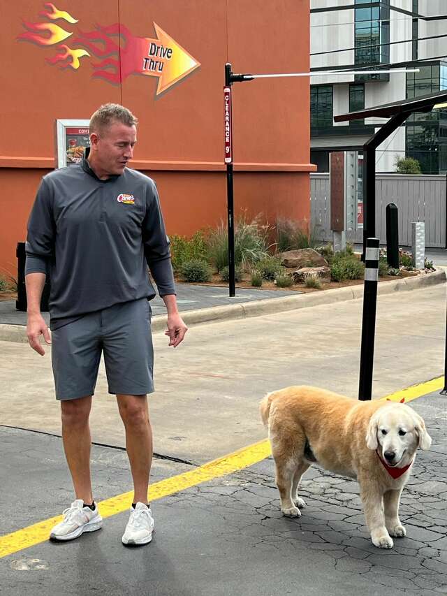 ESPN's Kirk Herbstreit and his dog meet Cane III at Raising Cane's