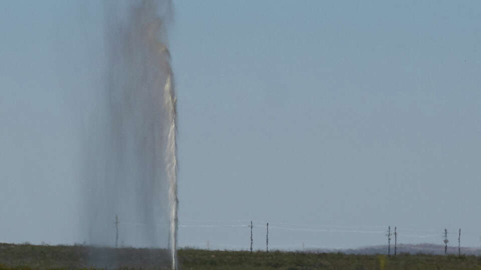 A geyser of salty water and oil spews out near a dry hole on Wednesday, Oct. 2, 2024 in Toyah, Texas.