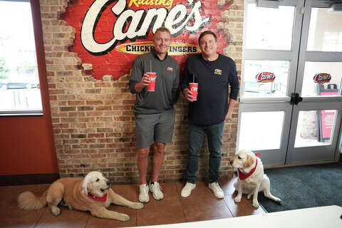 ESPN's Kirk Herbstreit and his dog meet Cane III at Raising Cane's