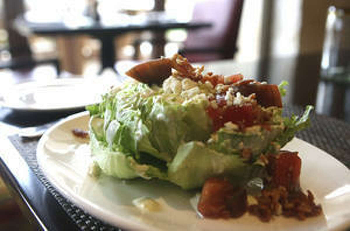 The wedge salad is topped with chunks of blue cheese and bacon at Cibolo Moon restaurant.
