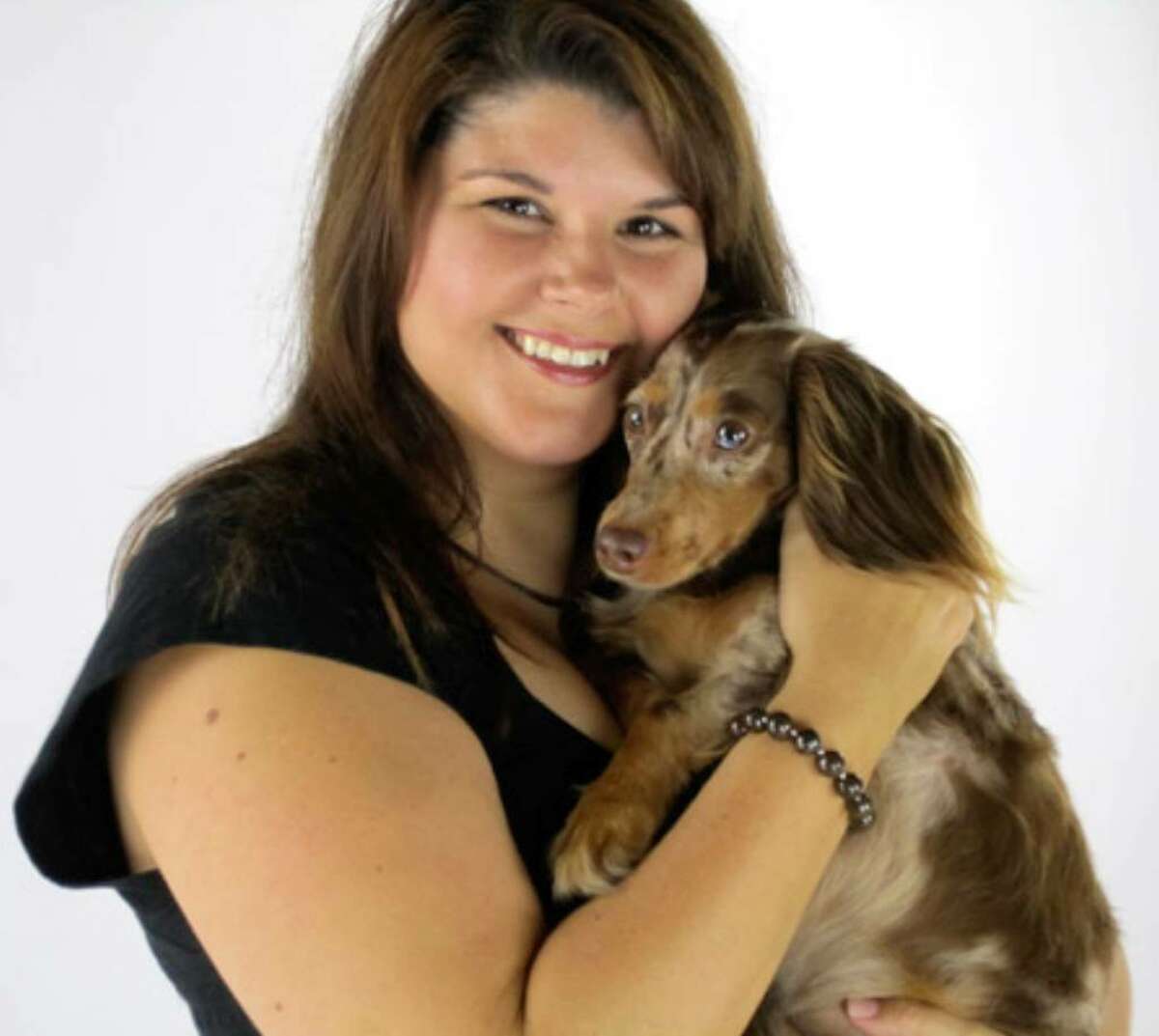 Holly Hirshberg holds Rainbow, who won second place in the Bissell Most Valuable Pet online contest. Rainbow’s photo will appear on Bissell products.