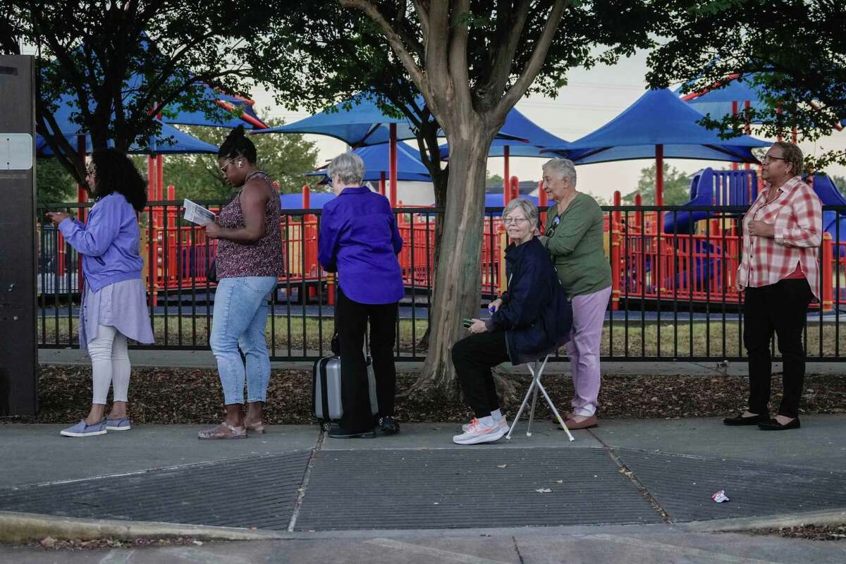 People wait in line for early voting on Monday, Oct. 21, 2024 at the West Gray Multi-service Center in Houston.