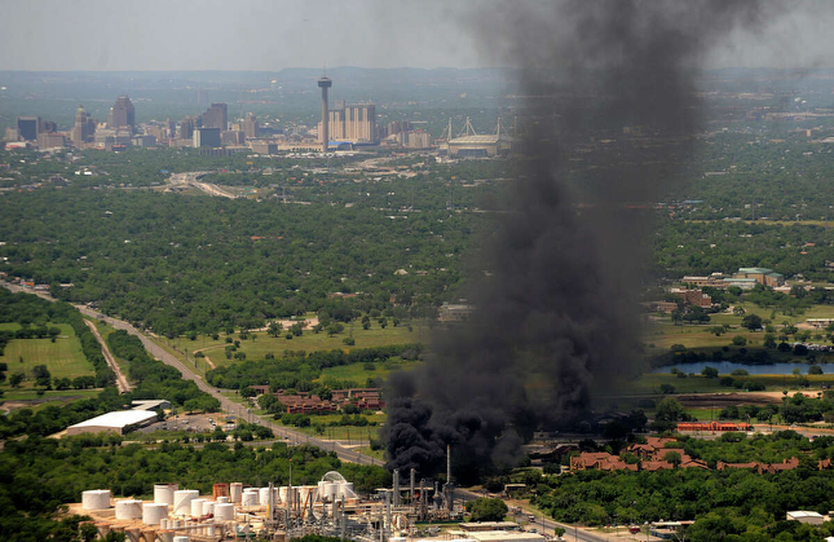 Downtown San Antonio is seen in the background as a fire at Southside refinery burns on Wednesday, May 5, 2010.