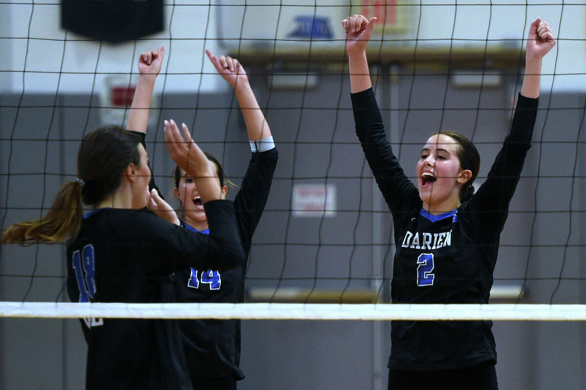 Savannah Leone (2) of Darien celebrates with teammates during a volleyball match against Glastonbury on September 4, 2024.