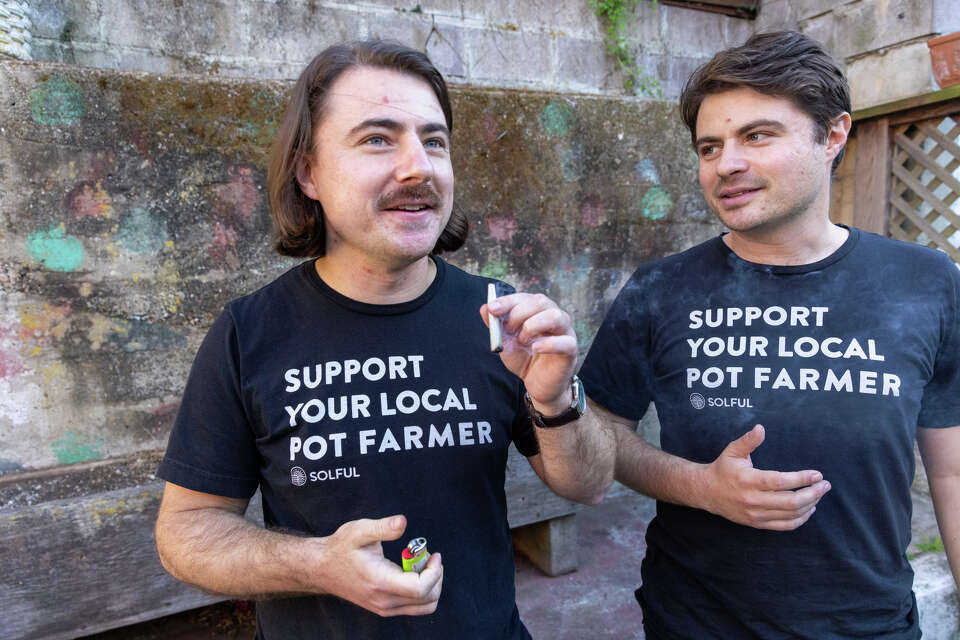 Noah Melrod, left, smokes a marijuana joint with his brother Eli in the backyard of their house in San Francisco on Oct. 15, 2024. Eli founded Solful, a chain of cannabis stores that sell cannabis flower grown by small artisanal farms.