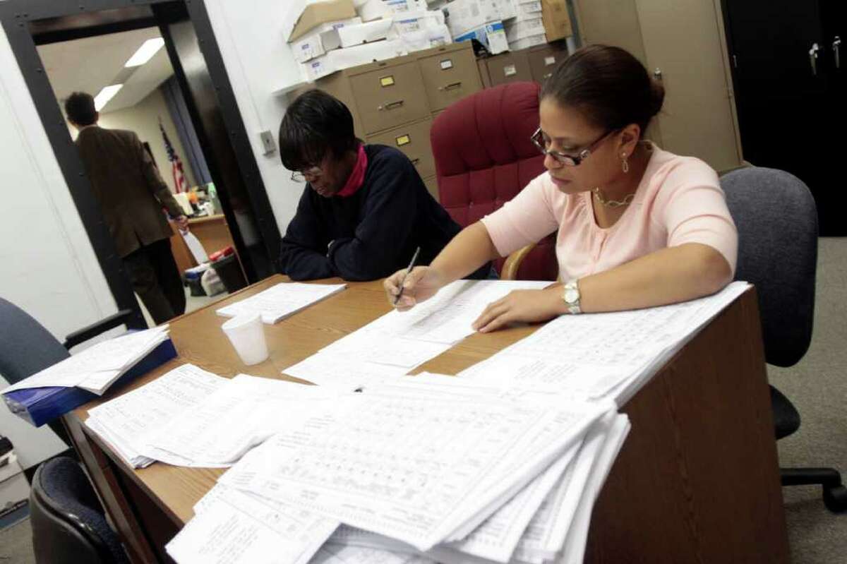 Workers count ballots at McLevy Hall in Bridgeport, Conn. in the early hours of Wednesday, Nov. 3rd.