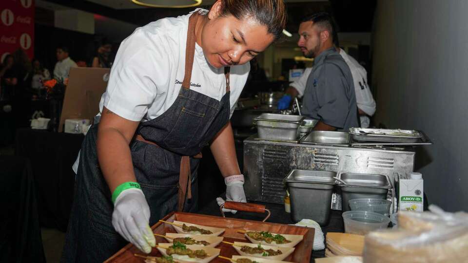 Benchawan Jabthong 'Chef G' Painter works on assembling pork satay with coconut mashed potatoes from Street to Kitchen during The Houston Chronicle’s annual Culinary Stars event, Thursday, Oct. 24, 2024, in Houston.