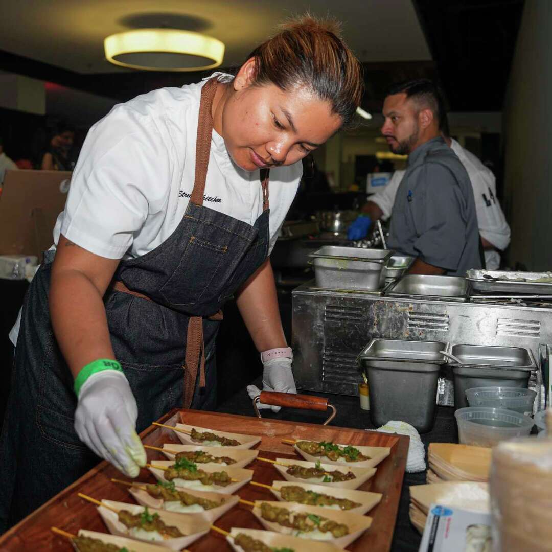 Benchawan Jabthong 'Chef G' Painter works on assembling pork satay with coconut mashed potatoes from Street to Kitchen during The Houston Chronicle's annual Culinary Stars event, Thursday, Oct. 24, 2024, in Houston.