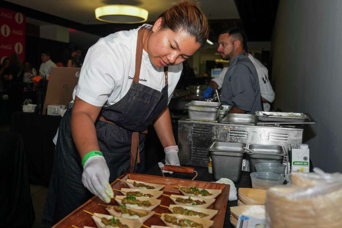 Benchawan Jabthong 'Chef G' Painter works on assembling pork satay with coconut mashed potatoes from Street to Kitchen during The Houston Chronicle’s annual Culinary Stars event, Thursday, Oct. 24, 2024, in Houston.