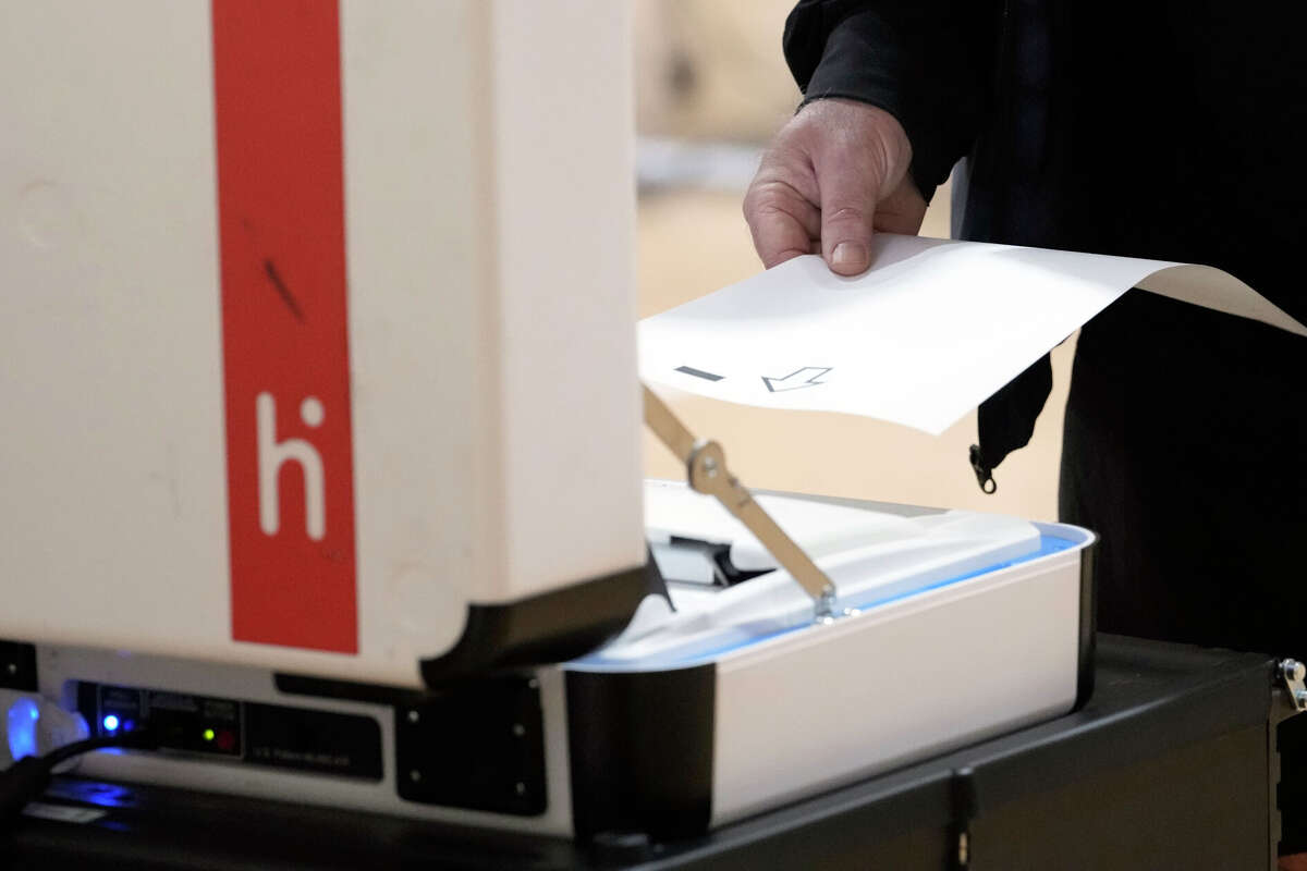 A man scans his paper ballot at West Gray Multi-Service Center, 1475 W Gray St., on Election Day Tuesday, Nov. 8, 2022, in Houston.
