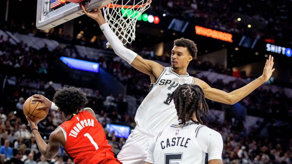San Antonio Spurs forward Victor Wembanyama guards gthe basket against Houston Rockets guard Amen Thompson (1)during the first half of their NBA home opener at the Frost Bank Center on Saturday, Oct. 26, 2024. The Spurs beat the Rockets 109-106.