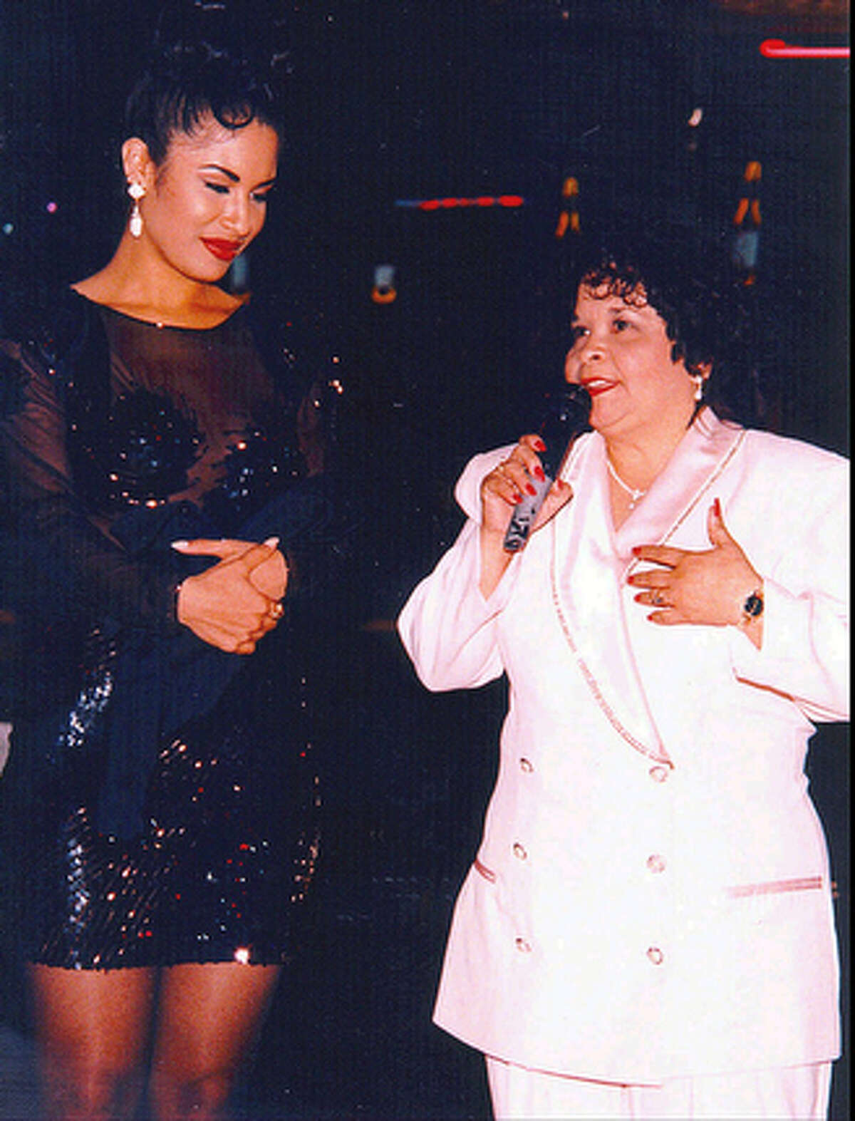 Tejano star Selena, left, watches as Yolanda Saldivar speaks to a crowd at a post-1994 Tejano Music Awards party in San Antonio, Texas.