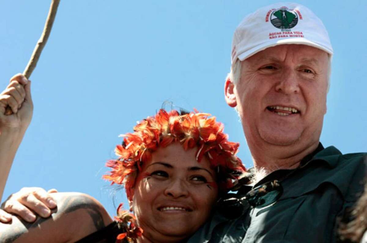 Director James Cameron (right) marches next to an unidentified indigenous woman during a protest against a proposed dam in the Amazon in Brasilia on Monday, April 12, 2010.