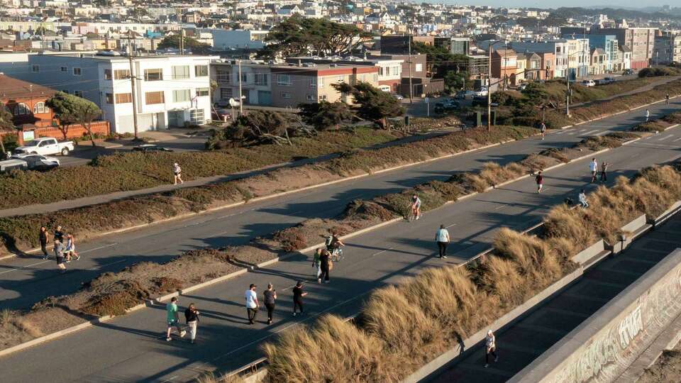 People on the Great Highway in San Francisco on Friday, Sept. 27, 2024. Voters will decide the future of the two-mile stretch in November. Proposition K would ban private vehicles on the Upper Great Highway between Lincoln Way and Sloat Boulevard. The road has been closed intermittently to traffic on a trial basis, making the road accessible to foot traffic.