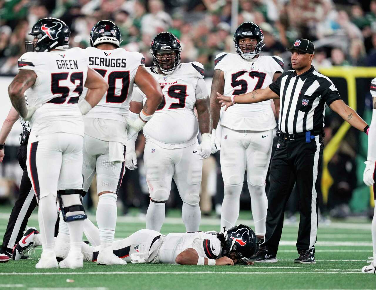 Houston Texans quarterback C.J. Stroud (7) is seen in the field after being tackled by New York Jets defensive end Solomon Thomas (94) during the first half of an NFL football game Thursday, Oct. 31, 2024, in East Rutherford.