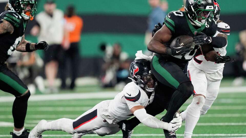 Houston Texans cornerback Derek Stingley Jr. (24) tackles New York Jets running back Breece Hall (20) during the second half of an NFL football game Thursday, Oct. 31, 2024, in East Rutherford.
