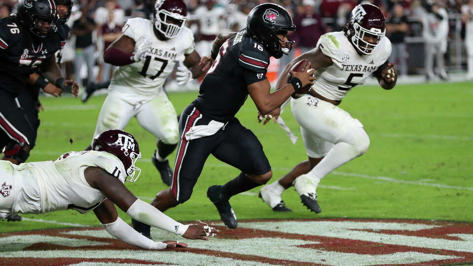 South Carolina quarterback LaNorris Sellers (16) runs away from Texas A&M defensive lineman Nic Scourton (11) and defensive lineman Shemar Turner (5) during the second half of an NCAA college football game Saturday, Nov. 2, 2024, in Columbia, S.C. (AP Photo/Artie Walker Jr.)