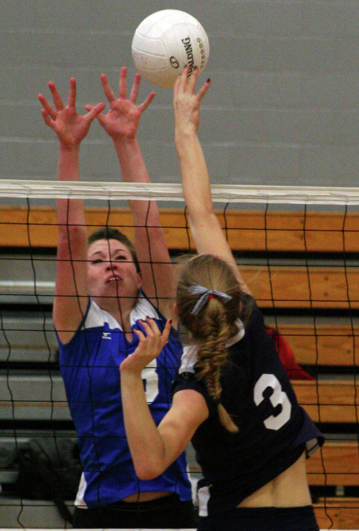 Fairfield Ludlowe's Maddi McCaffrey attempts a block on Staples' Augie Gradoux-Matt in the Falcons' 3-1 win over the Wreckers on Tuesday night at Fairfield Ludlowe High School.