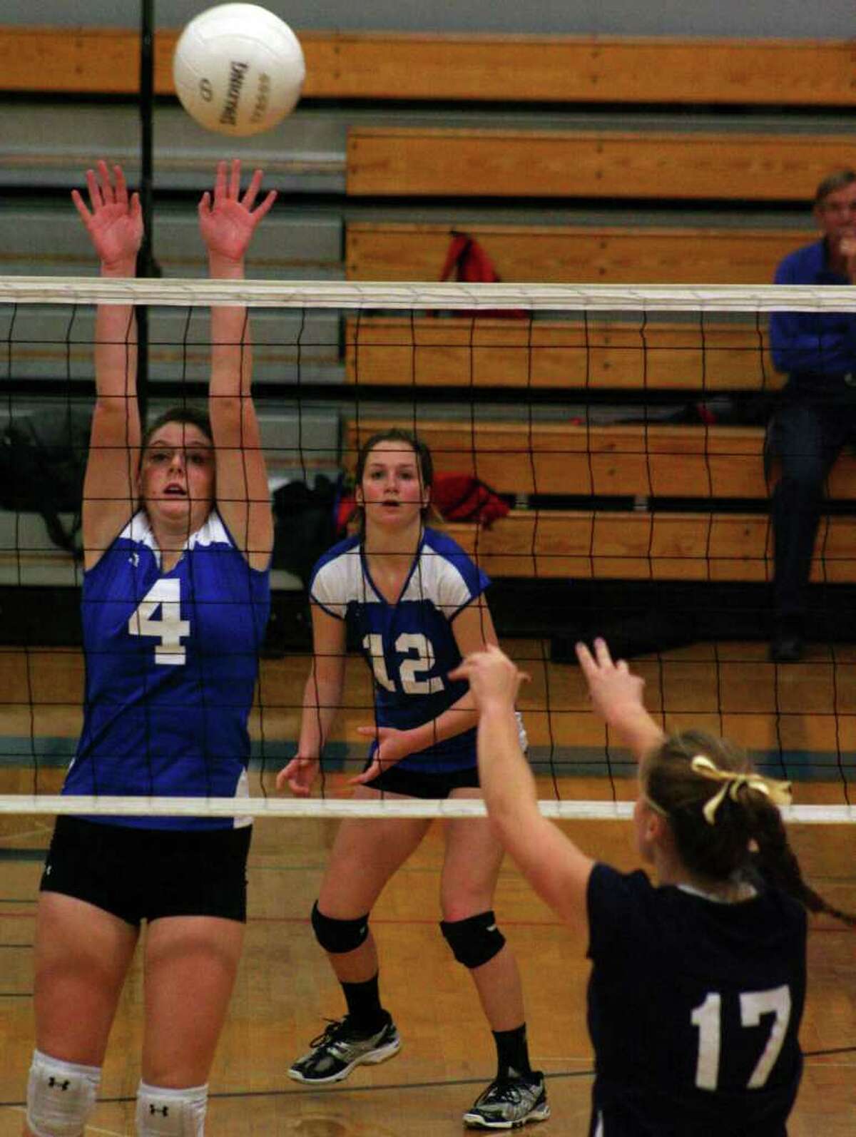 Fairfield Ludlowe's Dillon Casey blocks Staples' Kenzie Roof as Emily Nelson looks on in the Falcons 3-1 FCIAC quarterfinal win over the Wreckers on Tuesday night in Fairfield.