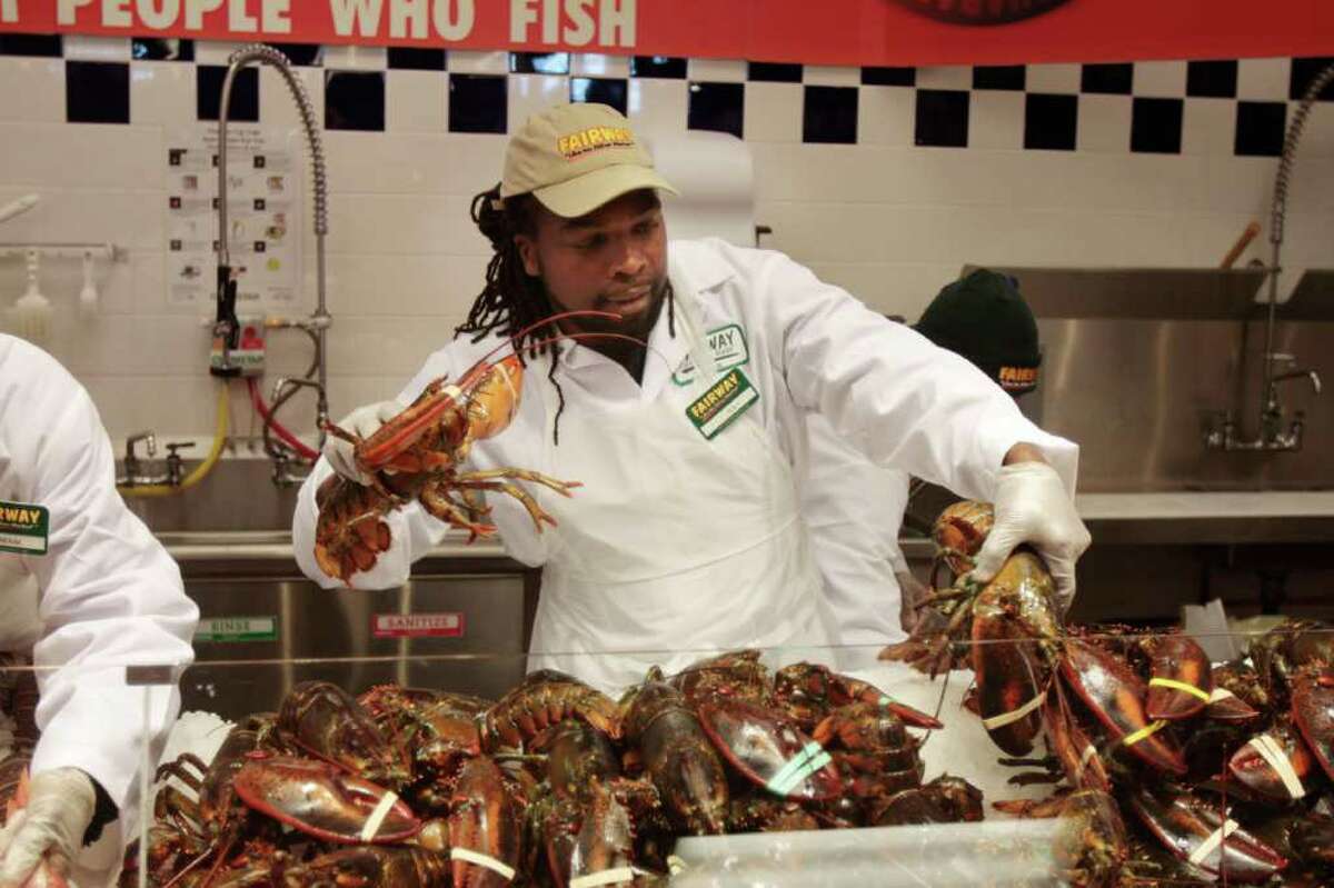 Ray Roe, of Stamford, wrangles live lobsters on opening day of Fairway Market in Stamford, Conn. on Wednesday November 3, 2010.