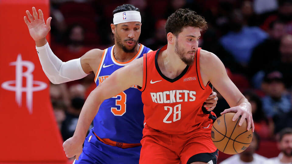 New York Knicks guard Josh Hart (3) reaches in as Houston Rockets center Alperen Sengun (28) spins to the basket during the first half of an NBA basketball game Monday, Nov. 4, 2024, in Houston. (AP Photo/Michael Wyke)