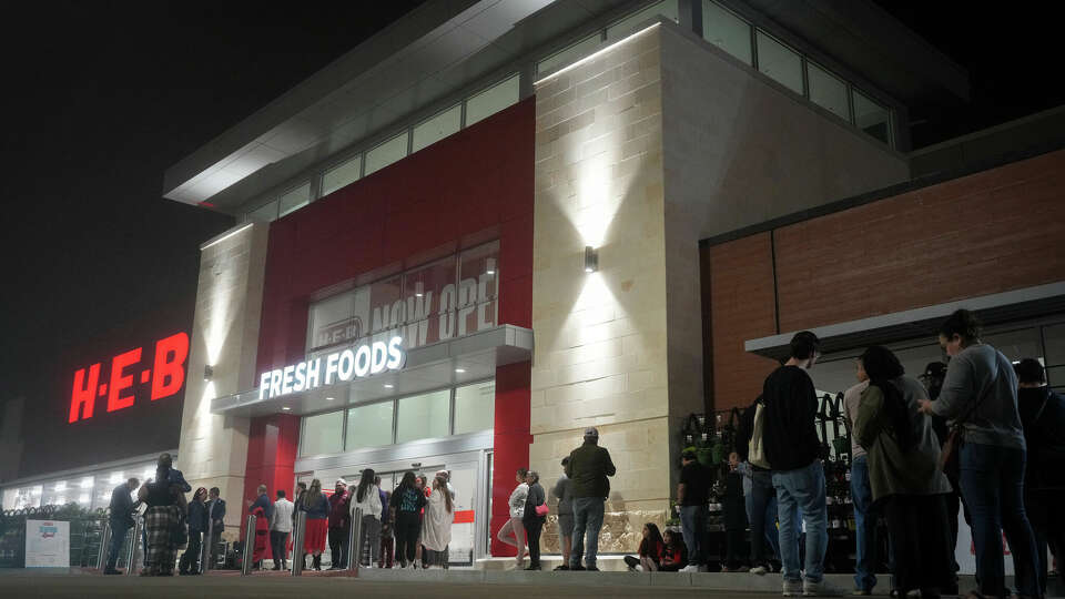 People line up outside before a grand opening event Wednesday, Feb. 21, 2024, at a new HEB store in Katy.