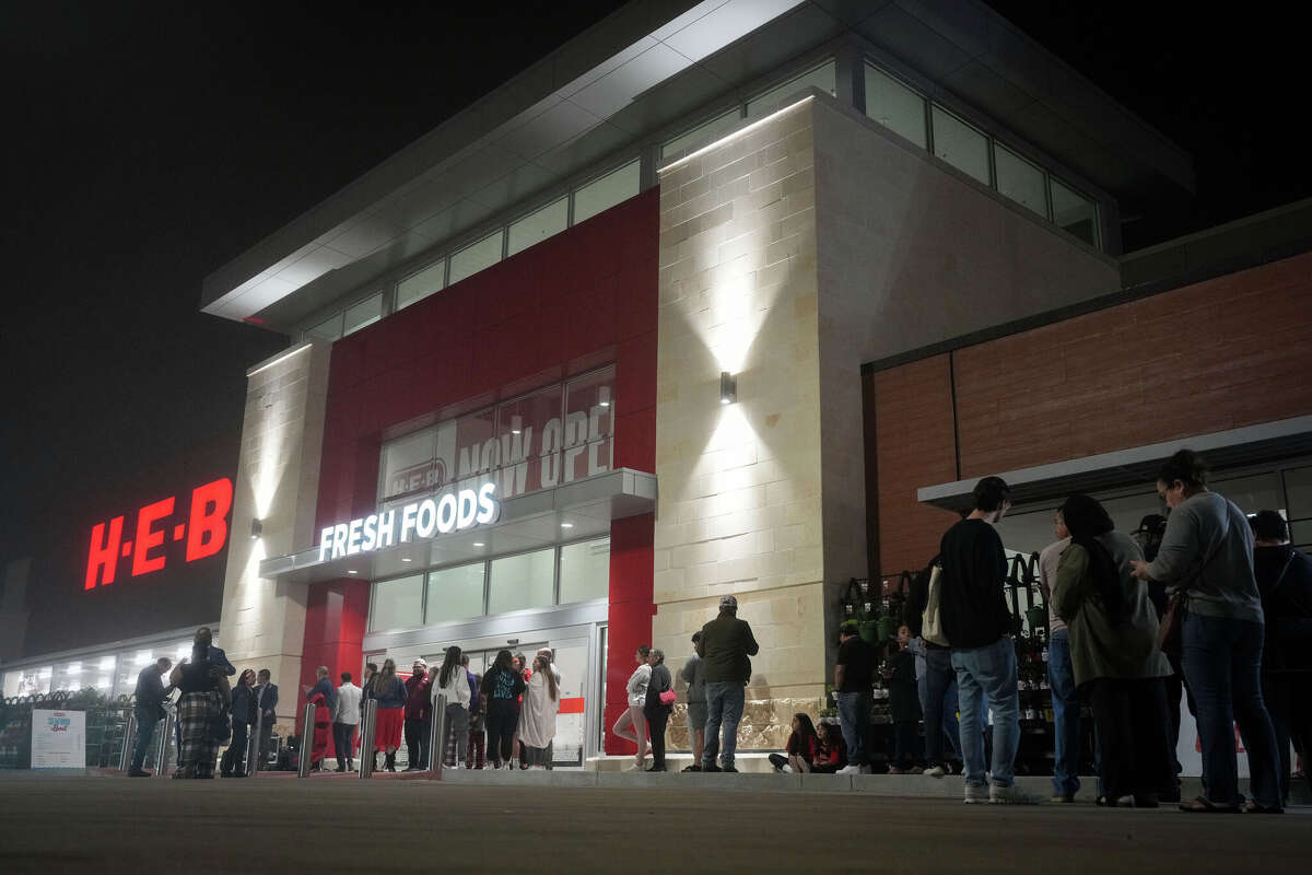 People line up outside before a grand opening event Wednesday, Feb. 21, 2024, at a new HEB store in Katy.