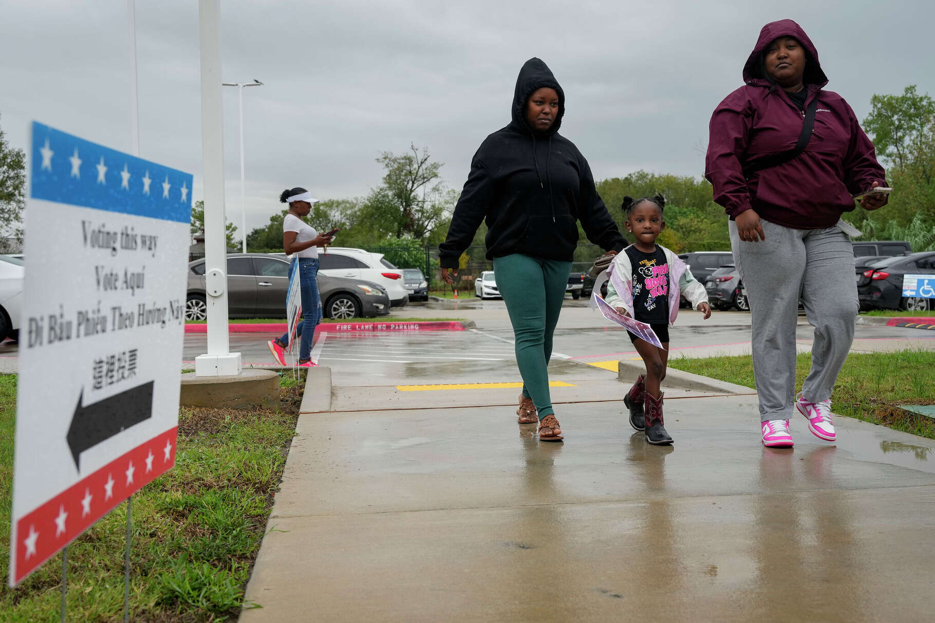 Lashonda Green, left, and Dyesha Murphy taking three-year-old Grayson Stewart to cast their votes for General Election on Election Day Tuesday, Nov. 5, 2024 at Sunnyside Health and Multi-Service Center in Houston.