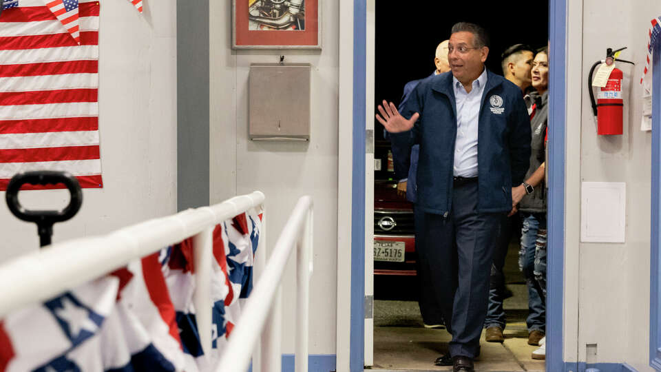 State Rep. John Lujan waves as he arrives at his campaign watch party held at Mission Open Air Market on Tuesday, Nov. 5, 2024, in San Antonio, Texas.