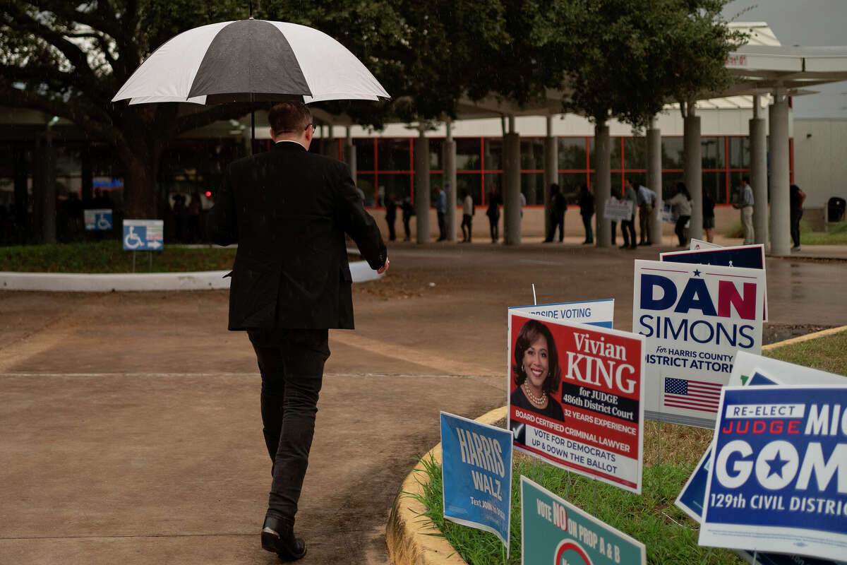 Despite heavy rain, people arrive to vote at the Metropolitan Multi-Service Center on November 5, 2024 in Houston, Texas. Americans cast their ballots today in the presidential race between Republican nominee former President Donald Trump and Democratic nominee Vice President Kamala Harris, as well as multiple state elections that will determine the balance of power in Congress. 