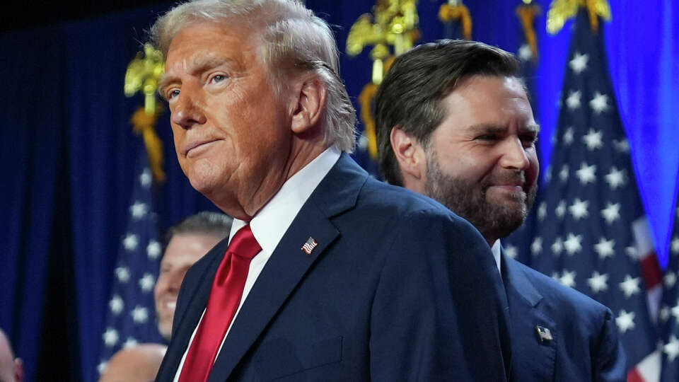 Republican presidential nominee former President Donald Trump and his running mate Sen. JD Vance, R-Ohio, stand on stage at an election night watch party at the Palm Beach Convention Center, Wednesday, Nov. 6, 2024, in West Palm Beach, Fla. (AP Photo/Evan Vucci)