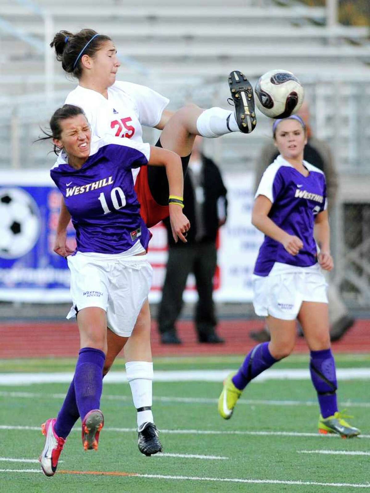 Aulona Veja, # 10 of Westhill, left, goes up against a high-kicking Sara Rosenband, # 25 of GHS, top, during the 2010 Girls FCIAC Soccer Championship between Greenwich High School vs. Westhill High School at Norwalk High School, Wednesday night, Nov. 3, 2010. Greenwich defeated Westhill, 1-0.