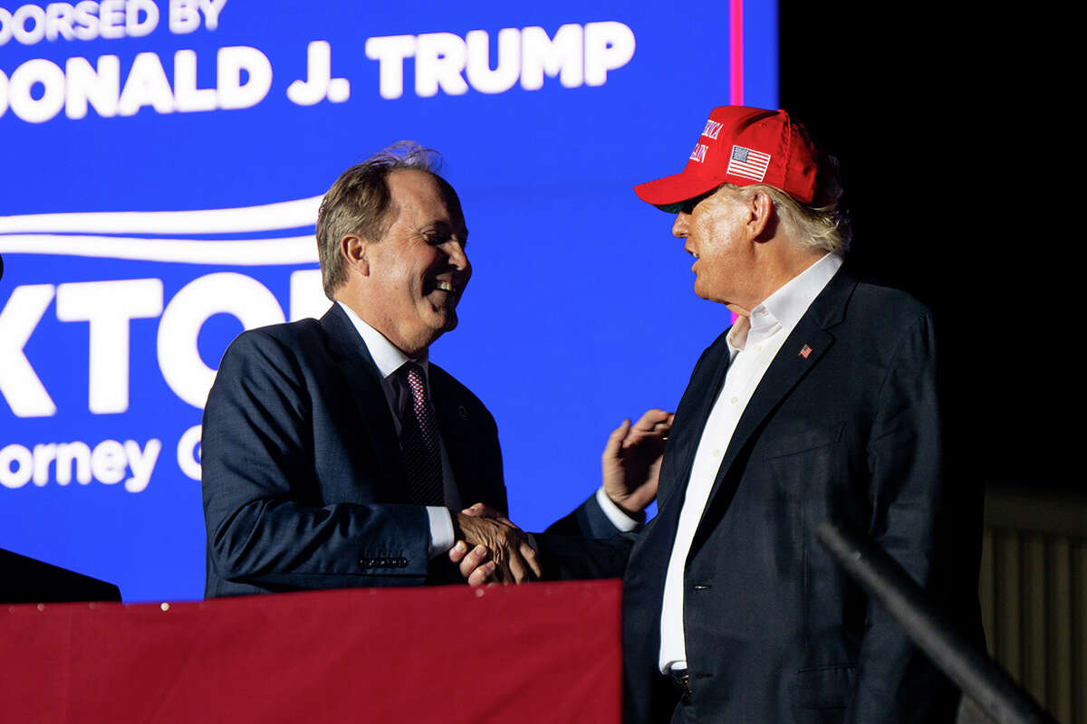 Texas Attorney General Ken Paxton, left, greets former President Donald Trump during a campaign rally in Robstown, Texas, on Oct. 22, 2022. (Brandon Bell/Getty Images/TNS)