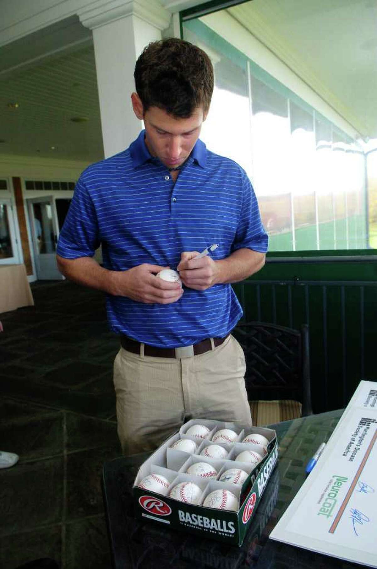 Craig Breslow signs baseballs at the annual Tim Teufel Charity Golf tournament at Tamarack Country Club in Greenwich, Conn. on Thursday October 28, 2010.