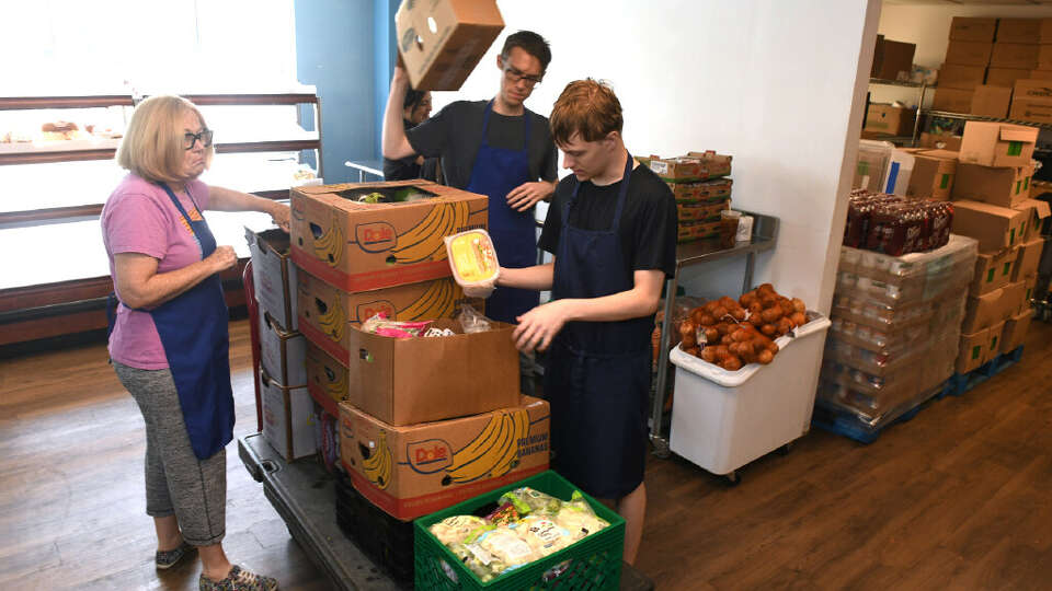 Volunteers unload donated food items in the community food pantry at the Bridgeport Rescue Mission in August. Food insecurity in Connecticut has increased over the past several years.