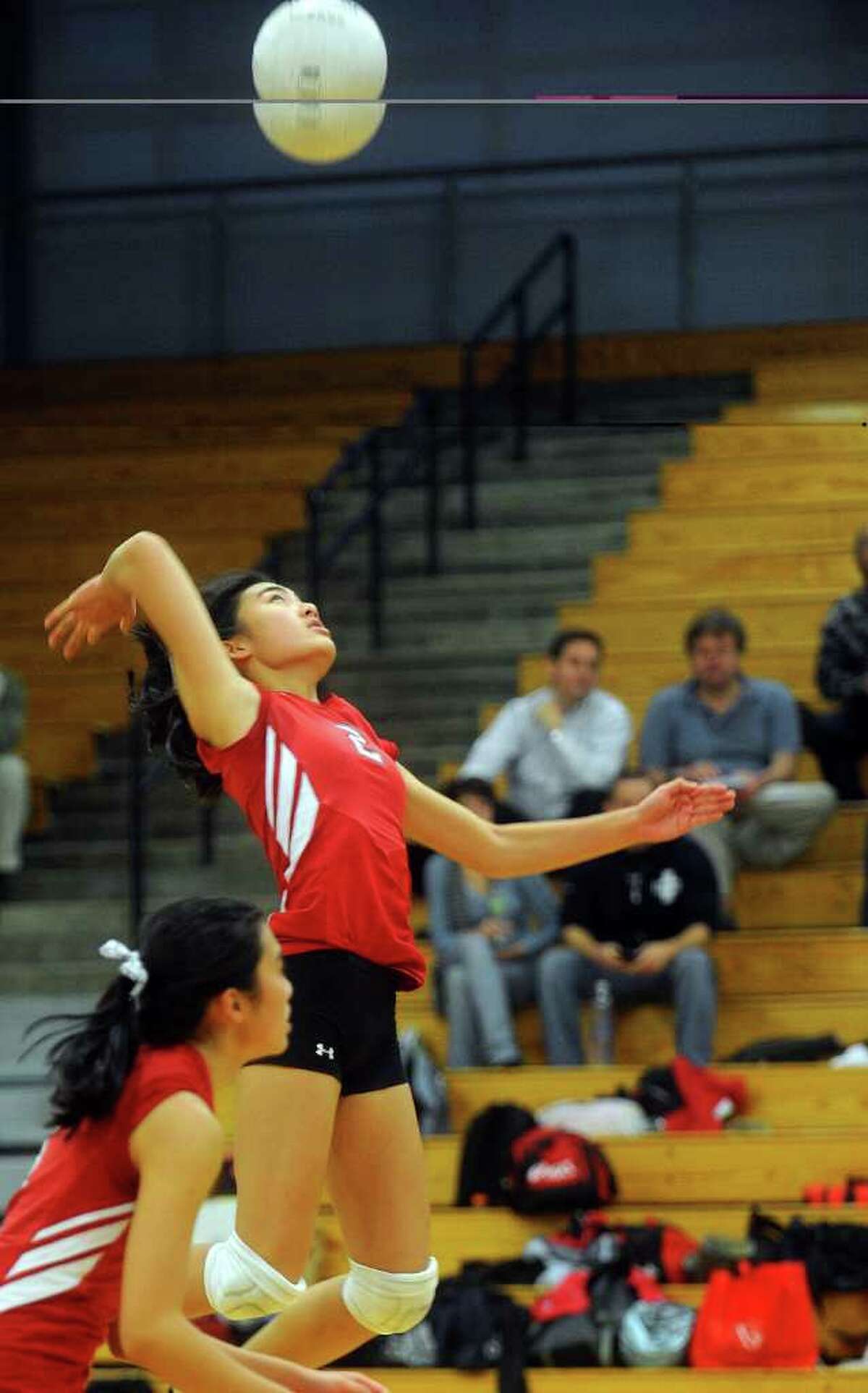 Greenwich's Kimberly Lo spikes the ball during Thursday's FCIAC volleyball semifinal game against Fairfield Ludlowe on the Falcons' home court on November 4, 2010.