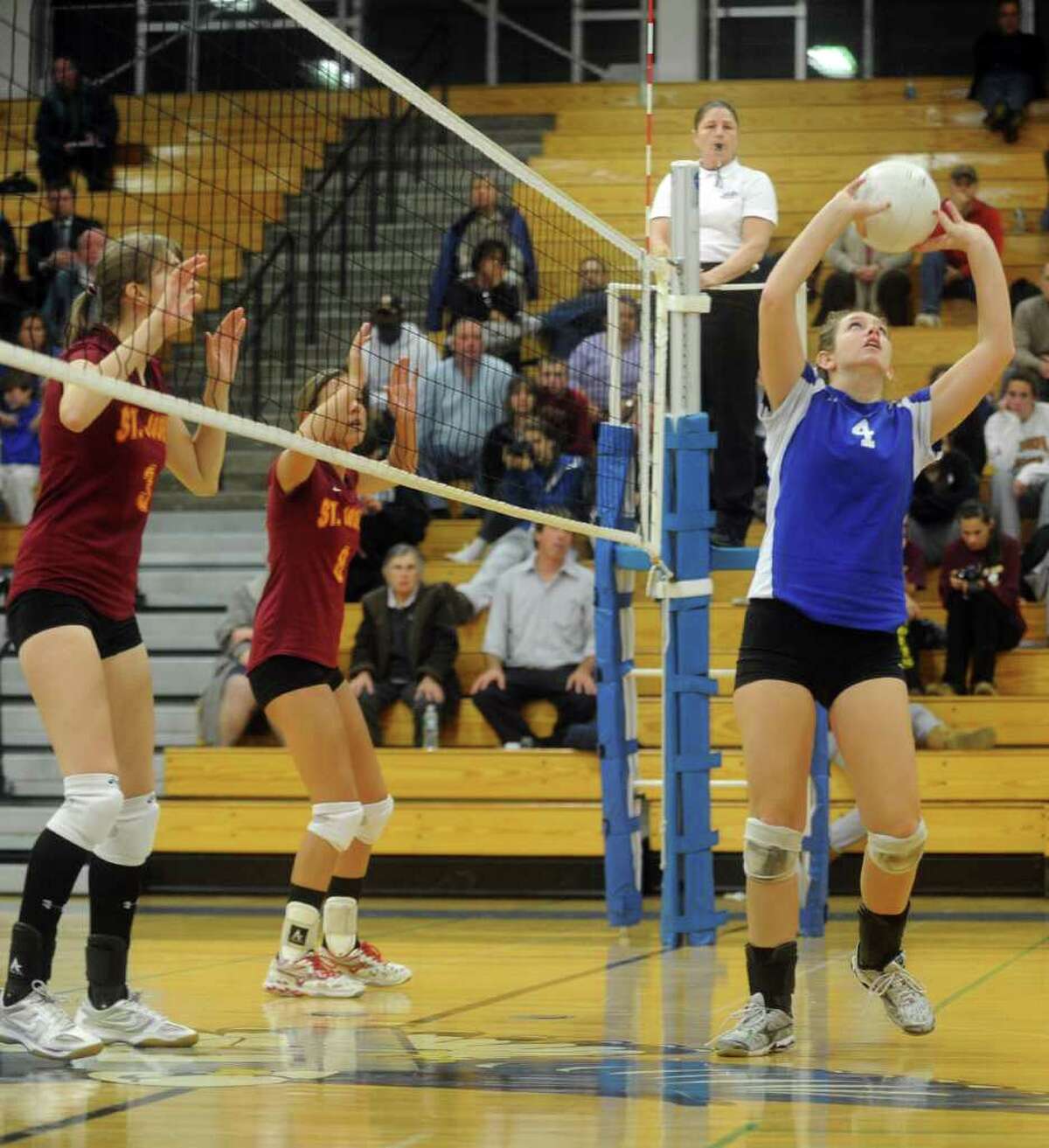 Darien's Mackenzie Begley, right, sets the ball during Thursday's FCIAC volleyball semifinal game against St. Joseph's at Fairfield Ludlowe High School on November 4, 2010.