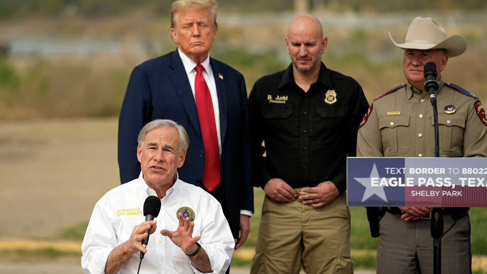 Republican presidential candidate former President Donald Trump listens as Texas Gov. Greg Abbott speak at Shelby Park at the U.S.-Mexico border, Thursday, Feb. 29, 2024, in Eagle Pass, Texas. At right is Freeman Martin, deputy director of Texas Homeland Security Operations and second from right is Brandon Judd, president of the National Border Patrol Council. (AP Photo/Eric Gay)