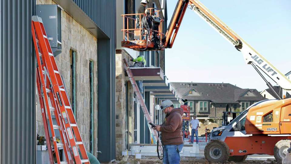 Workers continue construction on the Marcel Gardens shopping center at the intersection of Skyline and FM 1093 Wednesday, Nov. 20, 2024 in Fulshear, TX. The Houston suburb is the second fastest growing city in the county with a population that has increased from 1000 in 2010 to over 40,000 in 2023.